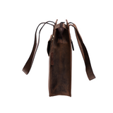 Side view of the Vintage Leather Leather Tote - Sorrel in brown, minimalist style with reinforced stitching, zipper closure, and two long shoulder straps, isolated on a white background.