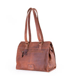The Leather Handbag Fennel by Vintage Leather Sydney is a brown tote with double shoulder straps, a front zippered pocket, and a leather tag. This spacious bag stands upright on a white background.