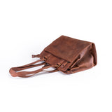 The Leather Handbag Fennel by Vintage Leather Sydney is a brown tote with double handles, shown on its side against a white background. It has a simple rectangular shape, visible seams, and metal hardware.