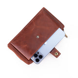 A brown leather phone wallet case with a snap-button closure, shown holding a light blue smartphone on a clean white background.