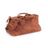 The Leather Duffle Bag Berlin by Vintage Leather Sydney is a brown leather bag with handles, a shoulder strap, brass hardware, and a distressed finish, shown against a white background.