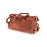 The Leather Duffle Bag Berlin by Vintage Leather Sydney, crafted in brown leather with handles, a shoulder strap, brass hardware, and multiple zippered pockets, is displayed on a white background to highlight its classic design.