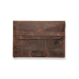 The Leather Laptop Sleeve 13 Inch Baxter by Vintage Leather Sydney features brown full-grain leather, a flap closure with a front strap, and a small animal logo. Its rustic look fits most 13-inch laptops.
