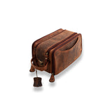 The Vintage Leather Sydney Leather Travel Toiletry Bag Porter, in brown leather, features two zippered compartments, an exterior pocket, and a small leather tag, displayed on a white background.