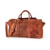 A brown distressed leather duffel bag with dual top handles, a detachable shoulder strap, and brass hardware, shown on a plain white background.