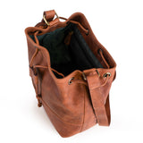 The Rosa Leather Crossbody Bag by Vintage Leather Sydney is a brown leather bucket bag with a shoulder strap and drawstring closure, shown from above with its roomy interior visible against a white background—ideal for your essentials.