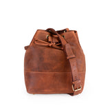 The Rosa Leather Crossbody Bag by Vintage Leather Sydney features a brown leather design with a buckle strap and gold-tone hardware, displayed against a plain white background.