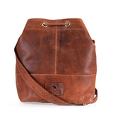 The Rosa Leather Crossbody Bag by Vintage Leather Sydney features a brown leather design, drawstring closure, single wide shoulder strap, and stitched brand patch. Its compact size is perfect for essentials, blending style with practicality.