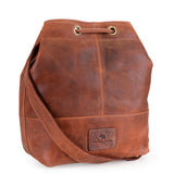 The Rosa Leather Crossbody Bag by Vintage Leather Sydney is a brown leather shoulder bag with a drawstring closure, wide strap, and a stitched front patch label. Stylish and practical, its ideal for everyday use.