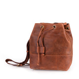 The Rosa Leather Crossbody Bag by Vintage Leather Sydney features a spacious main compartment, gold eyelets, front pocket, and adjustable shoulder straps, crafted from brown leather and displayed against a white background.