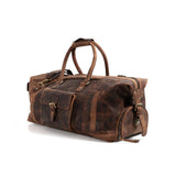 The Vintage Leather "ORLANDO" Leather Duffle Bag is a large brown bag with handles, a shoulder strap, buckle front pocket, and metal zippers—ideal for travel or gym—shown on a white background.