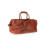 A brown distressed leather duffel bag with dual top handles and a detachable shoulder strap, shown on a plain white background.