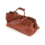 A brown distressed leather duffel bag with dual top handles and a detachable shoulder strap, shown on a clean white background.