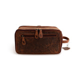 The Leather Travel Toiletry Bag Porter by Vintage Leather Sydney is a rectangular brown bag featuring two zipper pulls on the front pocket, a sturdy side handle, and a leather tag on a chain, displayed against a white background.