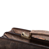 Close-up of the Parker Leather Mens Briefcase by Vintage Leather Sydney, showcasing its brass-colored clasp, zipper, and handle—an ideal professional accessory—set against a white background.