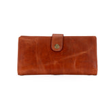 A brown leather clutch wallet with a snap-button strap closure, shown against a plain white background.
