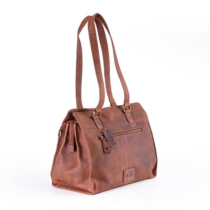 The Leather Handbag Fennel by Vintage Leather Sydney features double top handles, a zippered closure, and a small decorative tag, standing upright to show off its classic style and spacious design against a white background.