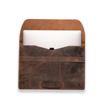 The Vintage Leather Sydney Laptop Sleeve 15 inch Bexley, in open brown full-grain leather, holds a partially visible white laptop against a white background.