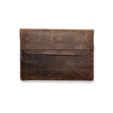 The Laptop sleeve 13 inch Bexley by Vintage Leather Sydney is a brown leather sleeve with a flap closure and minimal stitching, made for 13-inch laptops. It features a small logo on the bottom right and is shown against a white background.