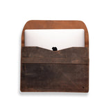 The Laptop Sleeve 15 inch Bexley by Vintage Leather Sydney, in brown full-grain leather, sits against a white background with its flap open to reveal a silver laptop partially inside.