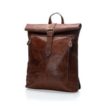 The Leather Backpack | Huston by Vintage Leather Sydney is a brown leather, roll-top laptop backpack with front buckle closure and two vertical zipper pockets, shown against a white background.