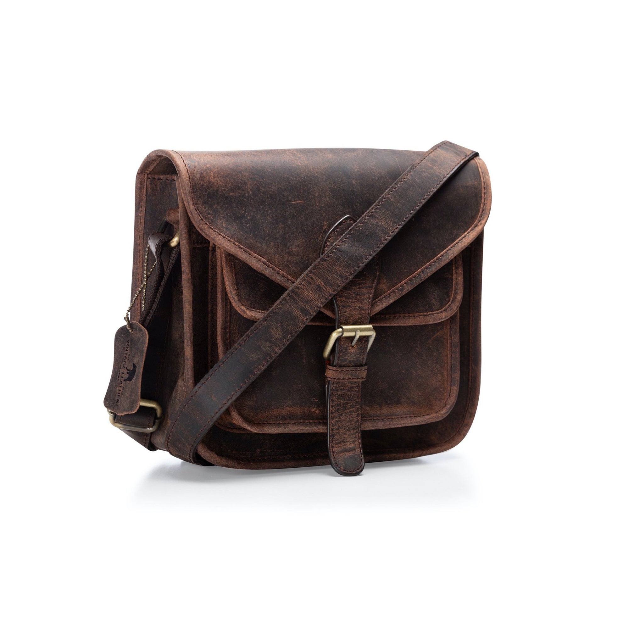The Vintage Leather Crossbody Bag Sedona features brown buffalo leather, a front buckle closure, a front pocket, and an adjustable shoulder strap, shown on a white background.