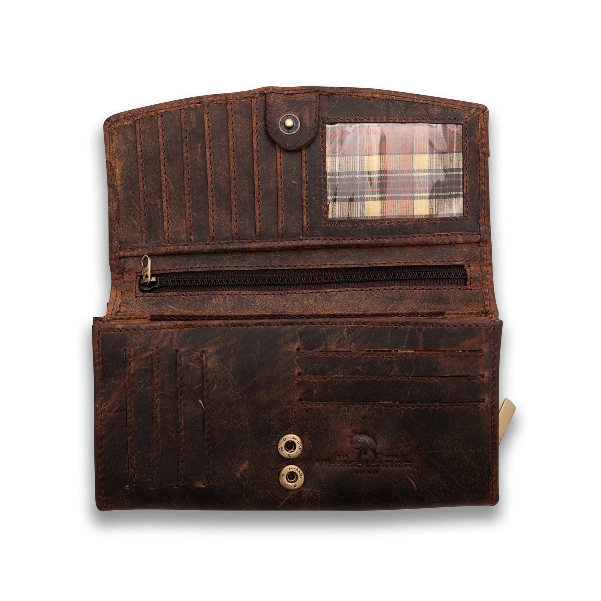 A Vintage Leather Sydney Leather Ladies Wallet Alice in worn brown features multiple card slots, a transparent plaid-backed ID window, a zippered pocket, and two metal snap buttons, shown open on a white background.