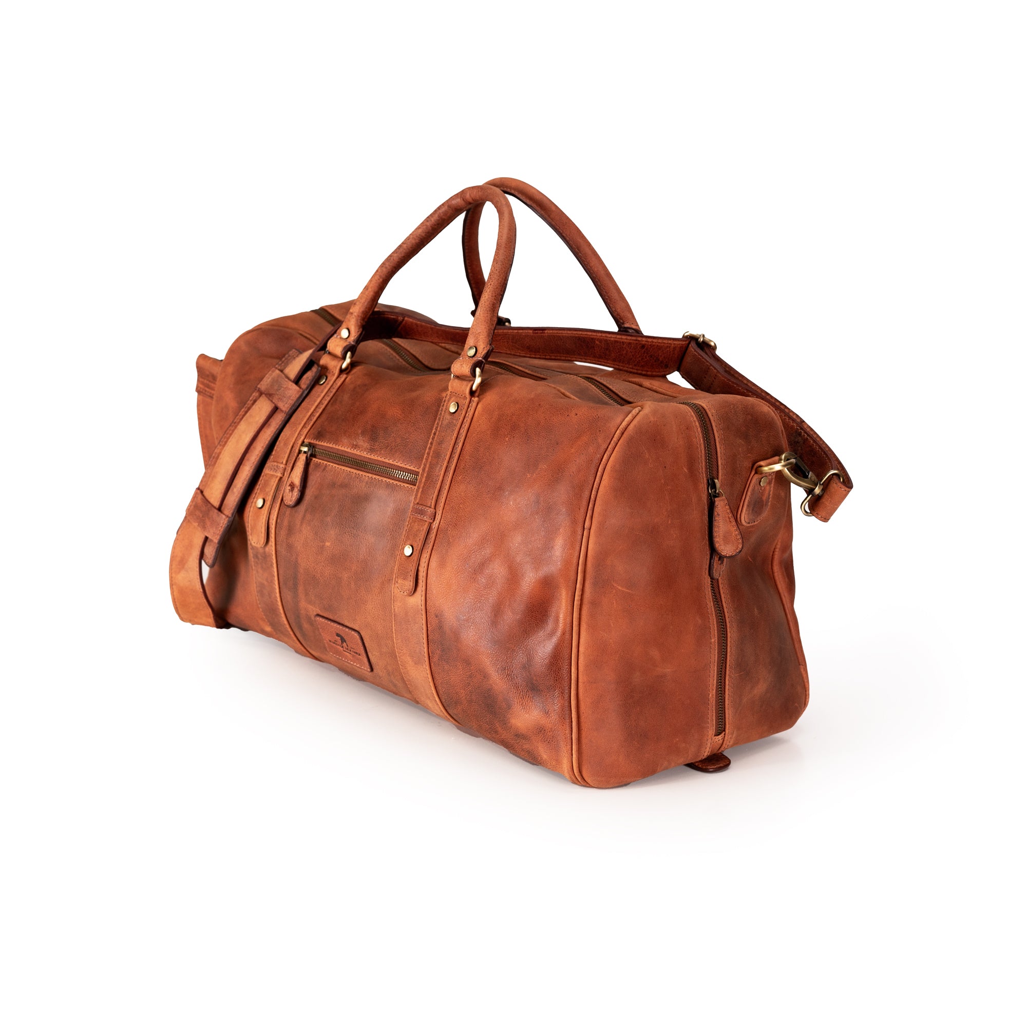 A brown distressed leather duffel bag with dual top handles, a detachable shoulder strap, and brass hardware, shown on a white background.