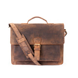 Brown leather satchel with shoulder strap on a white background