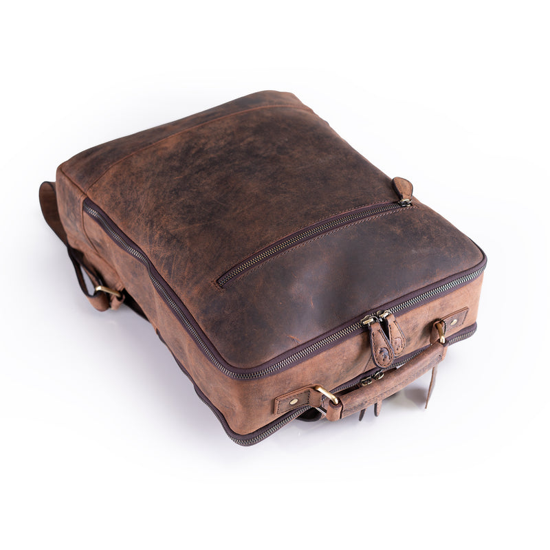 The Leather Travel Backpack Ryde by Vintage Leather Sydney, featuring visible zippers, sturdy stitching, and metal hardware, is shown lying flat on a white background—ideal for carrying your essentials in style.