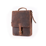The Ryder Courier Satchel by Vintage Leather Sydney is a vintage-style brown leather bag with a top handle, buckle closure, and adjustable shoulder strap—perfect for classic elegance and practical style, shown upright against a white background.
