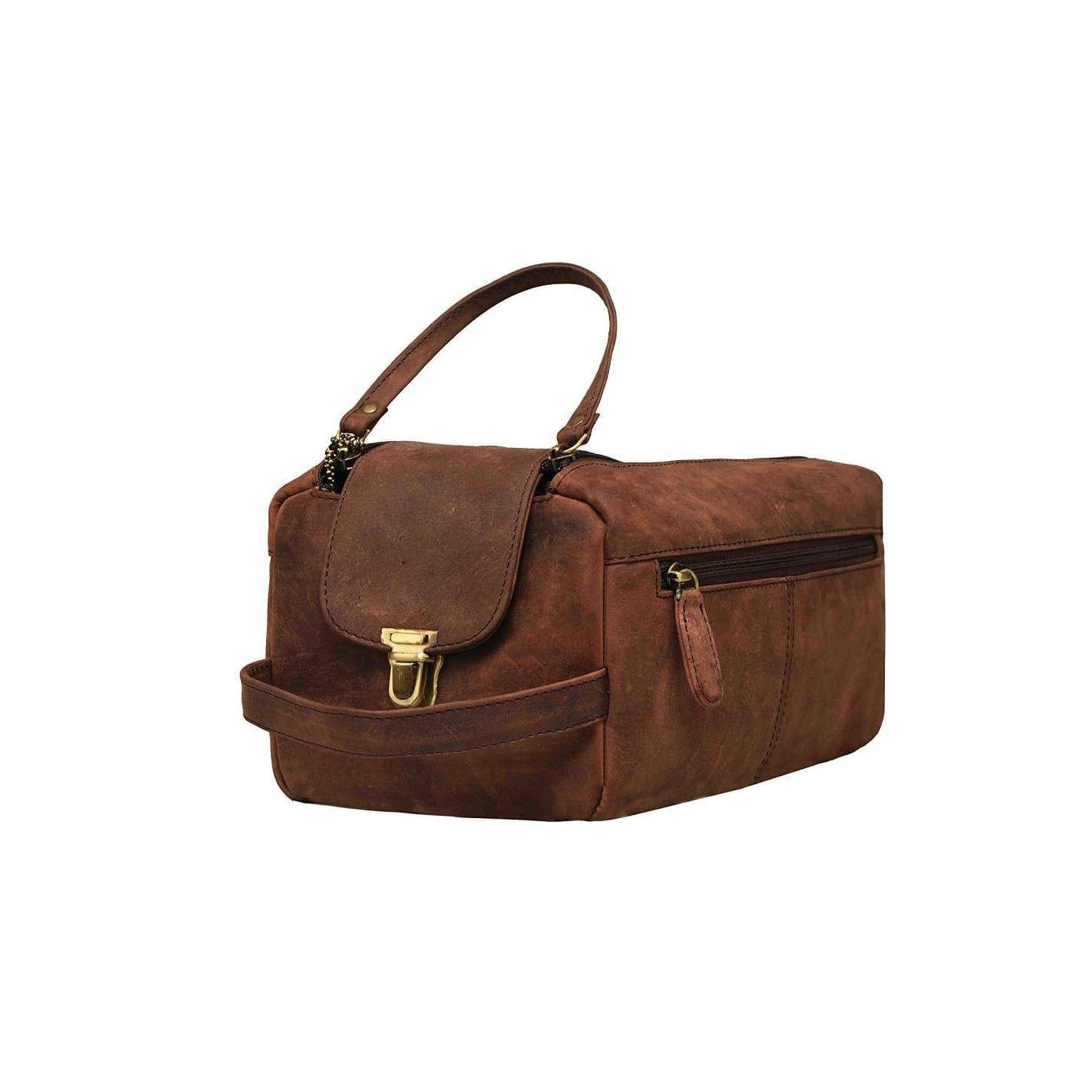 The Vintage Leather Toiletry Bag Johnson features brown leather, a top handle, gold front clasp, and side zipper pocket—ideal for bathroom storage. Displayed against a plain white background.