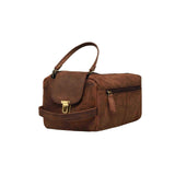 The Vintage Leather Toiletry Bag Johnson features brown leather, a top handle, gold front clasp, and side zipper pocket—ideal for bathroom storage. Displayed against a plain white background.
