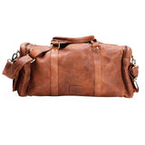 The Leather Duffle Bag - Colorado by Vintage Leather Sydney is a brown handmade bag with a top handle, adjustable shoulder strap, and gold-tone hardware—ideal as a stylish travel companion.