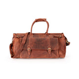 A distressed brown leather duffel bag with dual top handles, a detachable shoulder strap, and brass buckle details, shown against a plain white background.